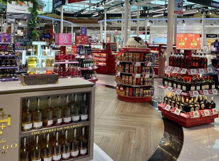 Bottles of whisky and other spirits displayed at Dubai Duty Free for travelers flying to India.